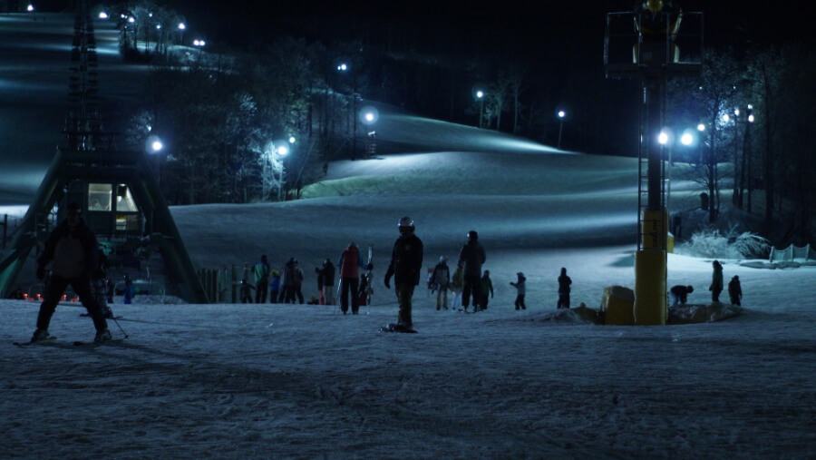 A group of people participating in night skiing