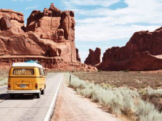 A camper van full of people sharing fun road trip questions