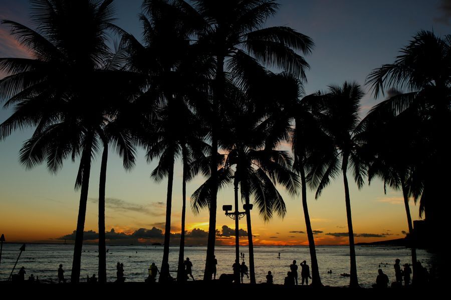 People watching a sunset on Oahu from Waikiki Beach