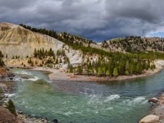 The Yellowstone River curving around the bend between two mountains