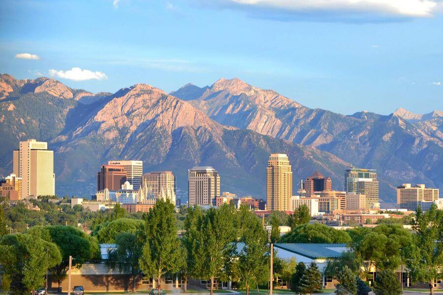 The skyline of downtown Salt Lake City on a sunny day with the Wasatch Mountains in the background