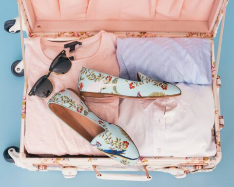 A suitcase full of items from a cruise packing list