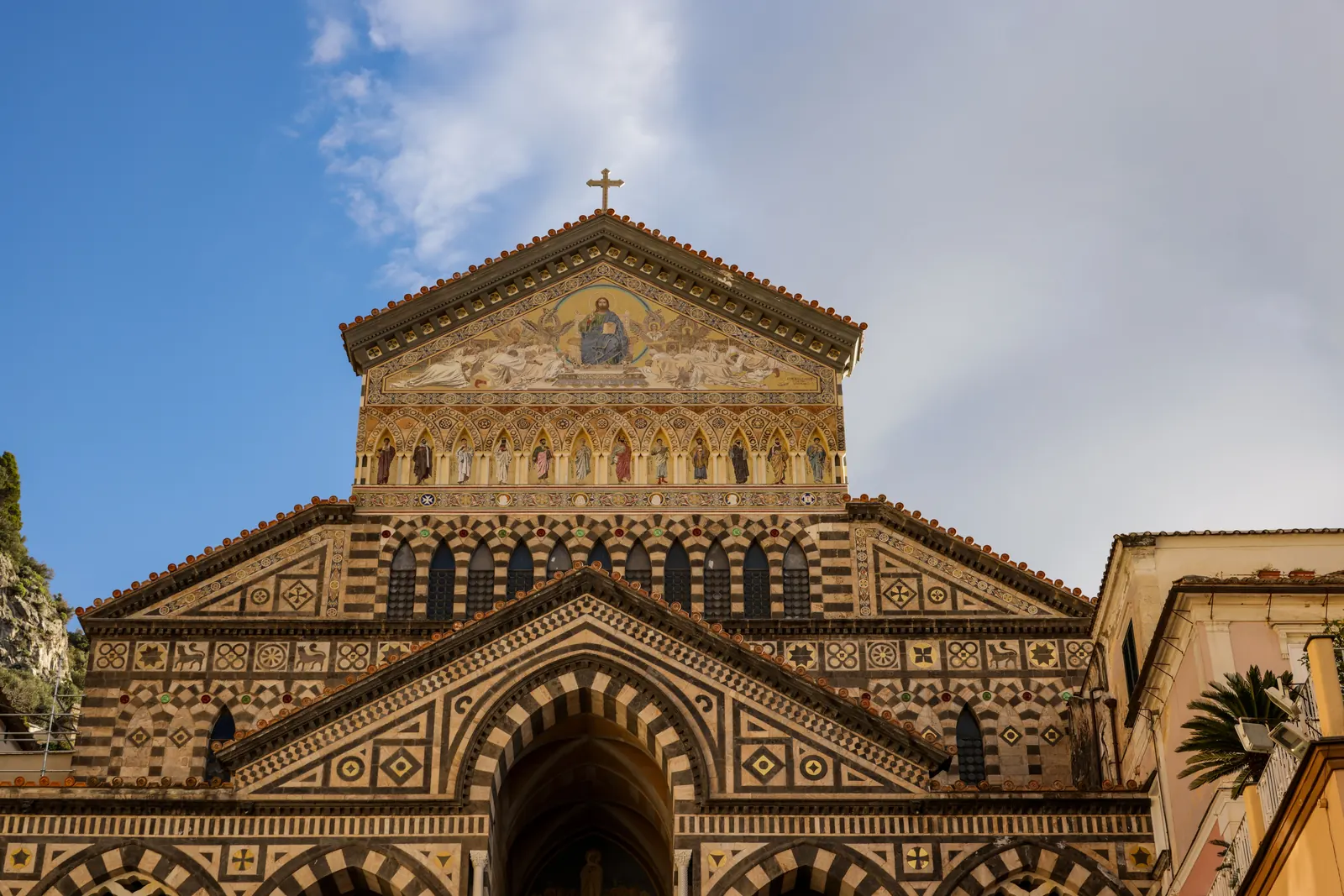 The striped facade and golden mosaic of the Amalfi Cathedral