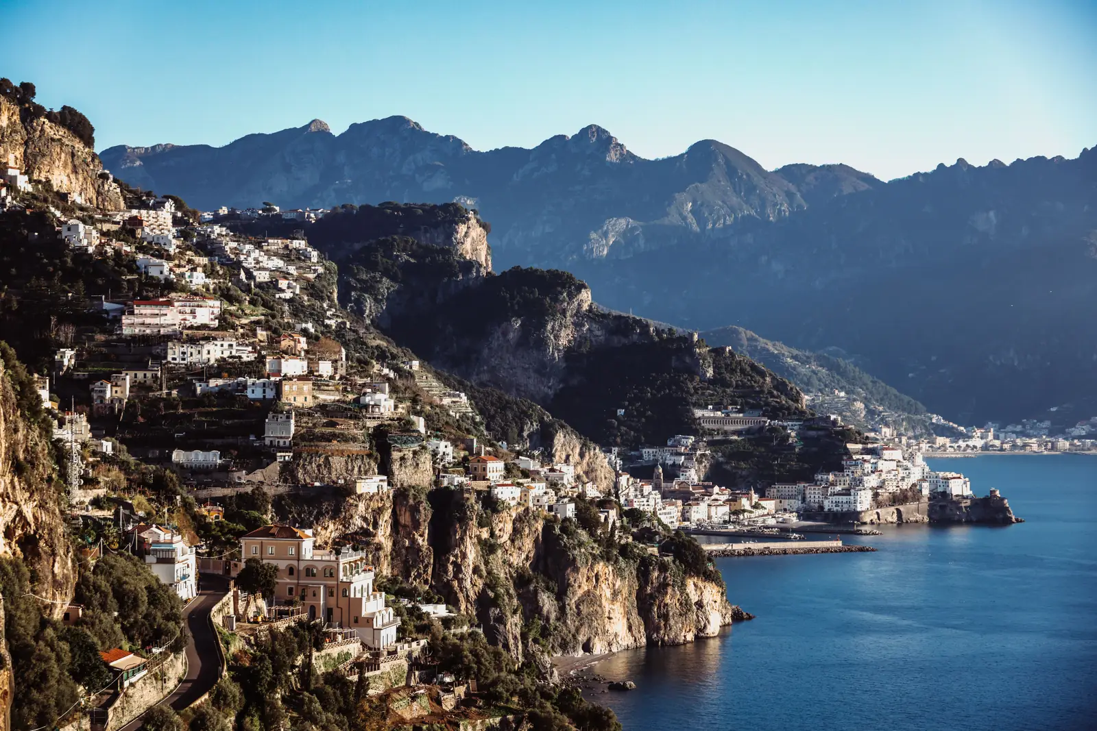 View along the Amalfi Coast with cliffside towns and layered mountains
