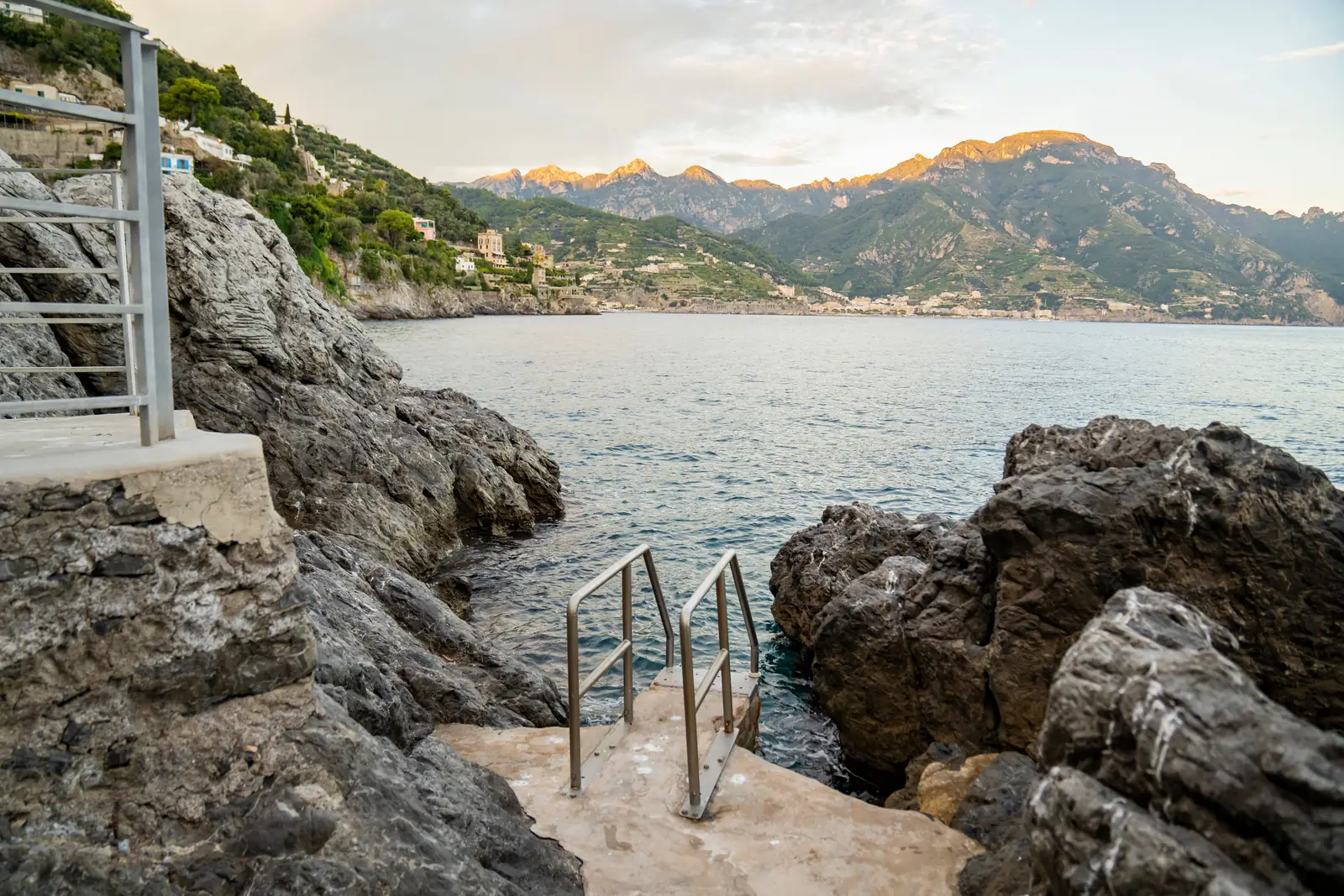 A rocky swimming spot with clear water along the Amalfi Coast