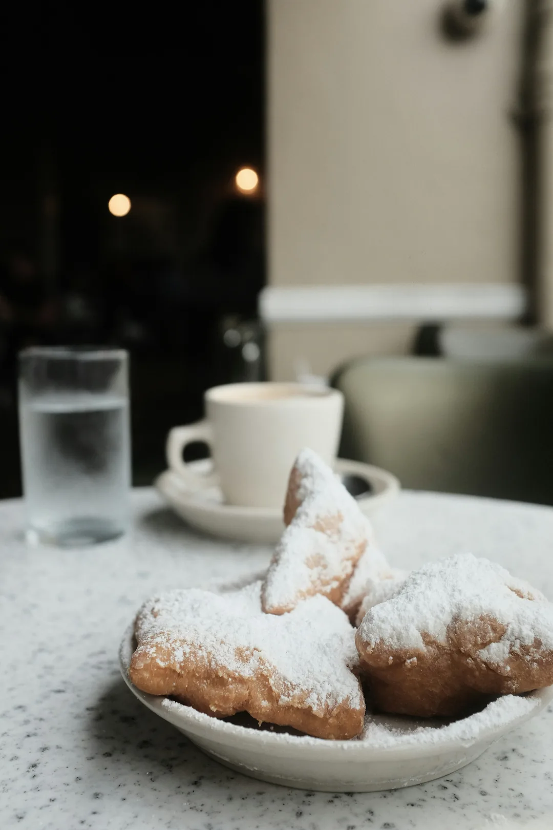 Powdered sugar beignets and coffee at a New Orleans cafe