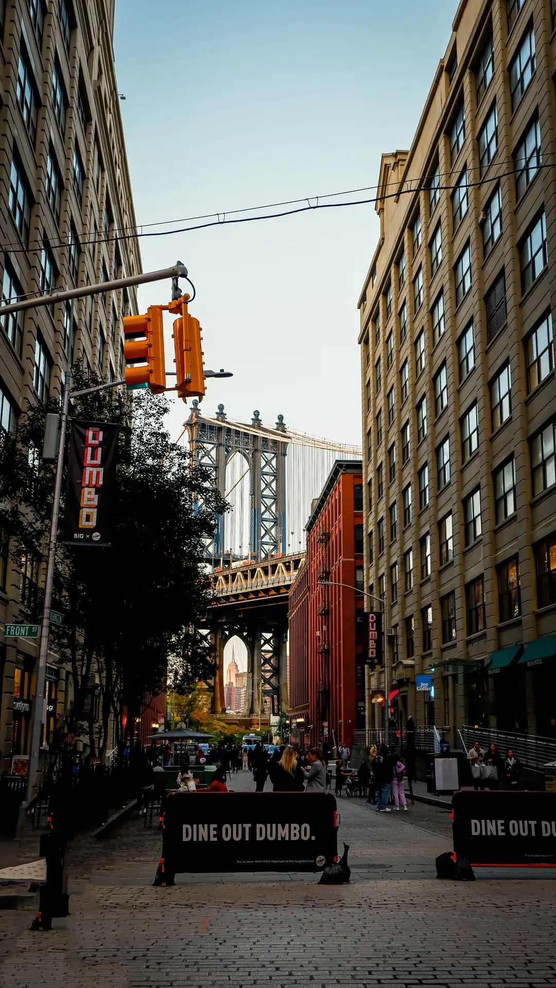 Manhattan Bridge framed between brick buildings in DUMBO Brooklyn