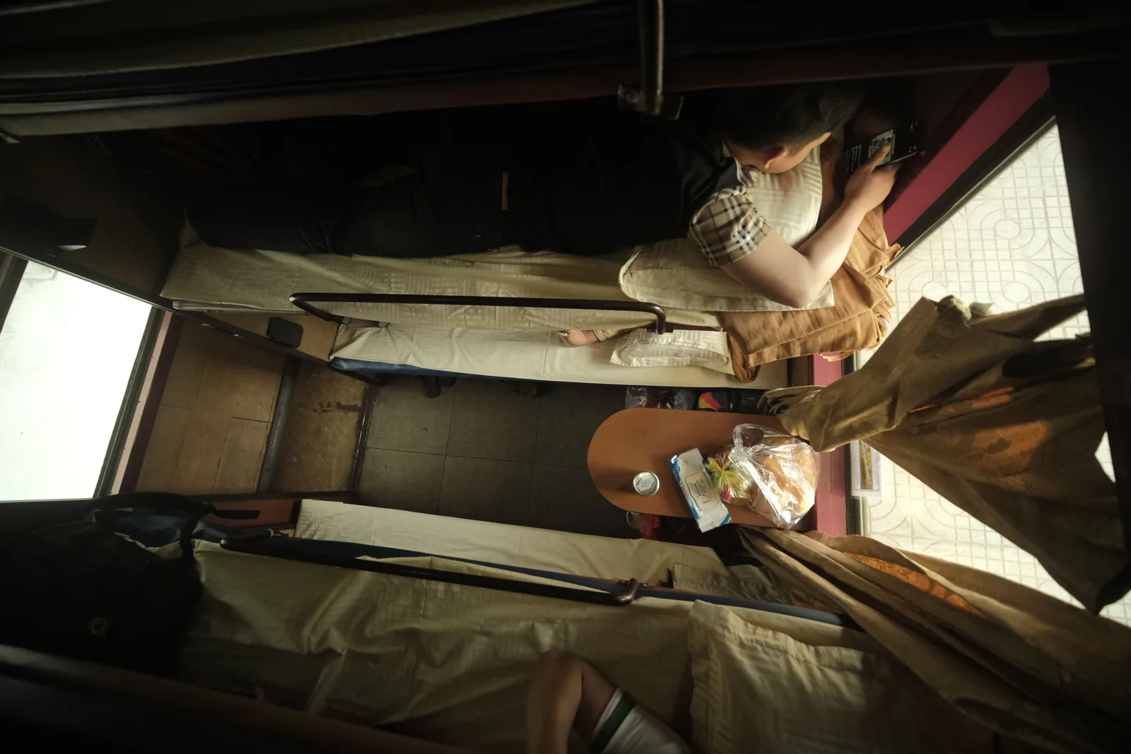 Passengers resting in the bunks of an overnight sleeper train