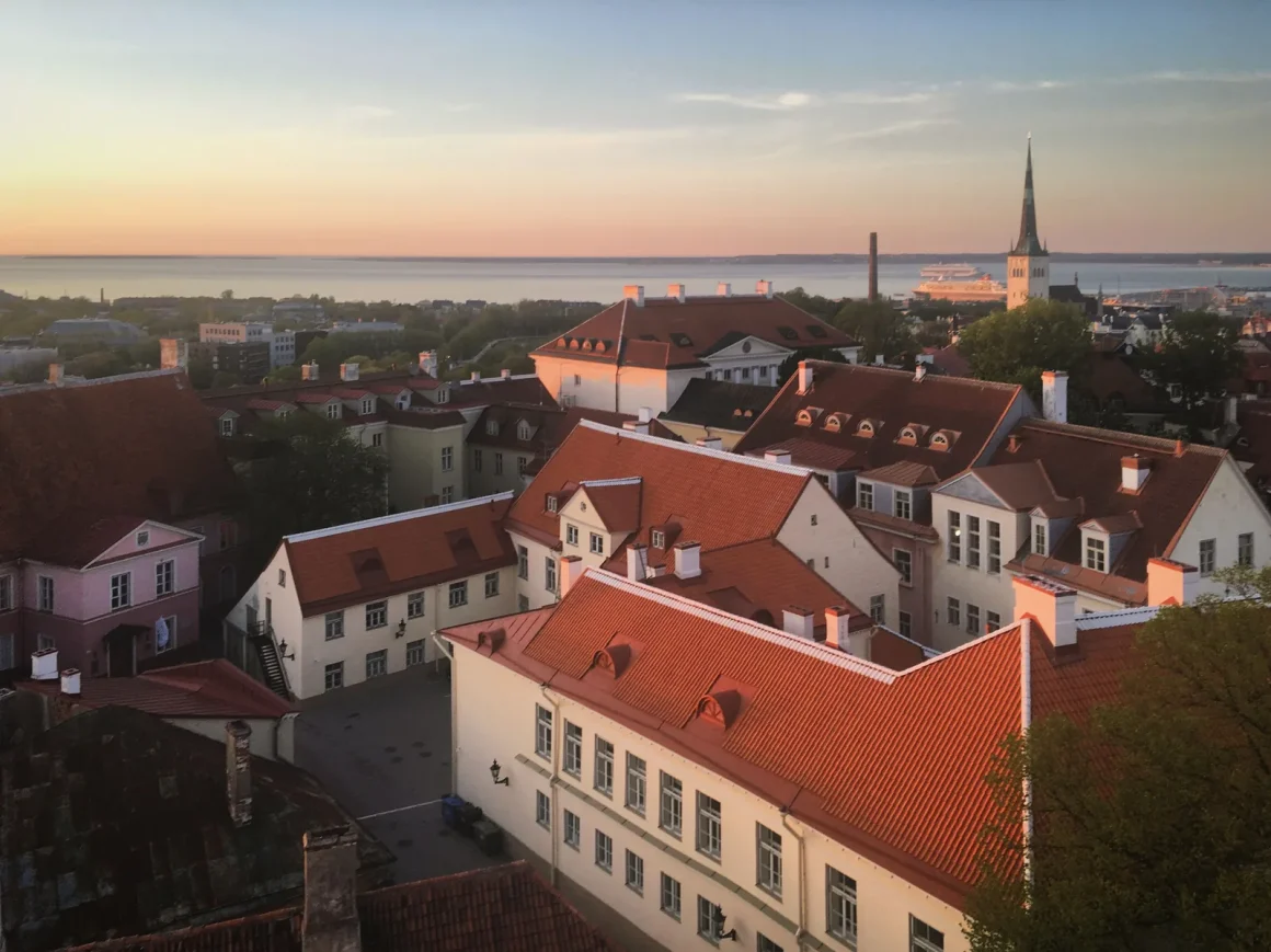 Red rooftops and church spires of a historic European old town at sunset