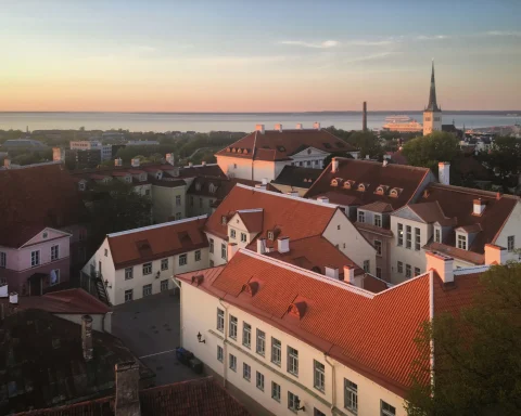 Red rooftops and church spires of a historic European old town at sunset