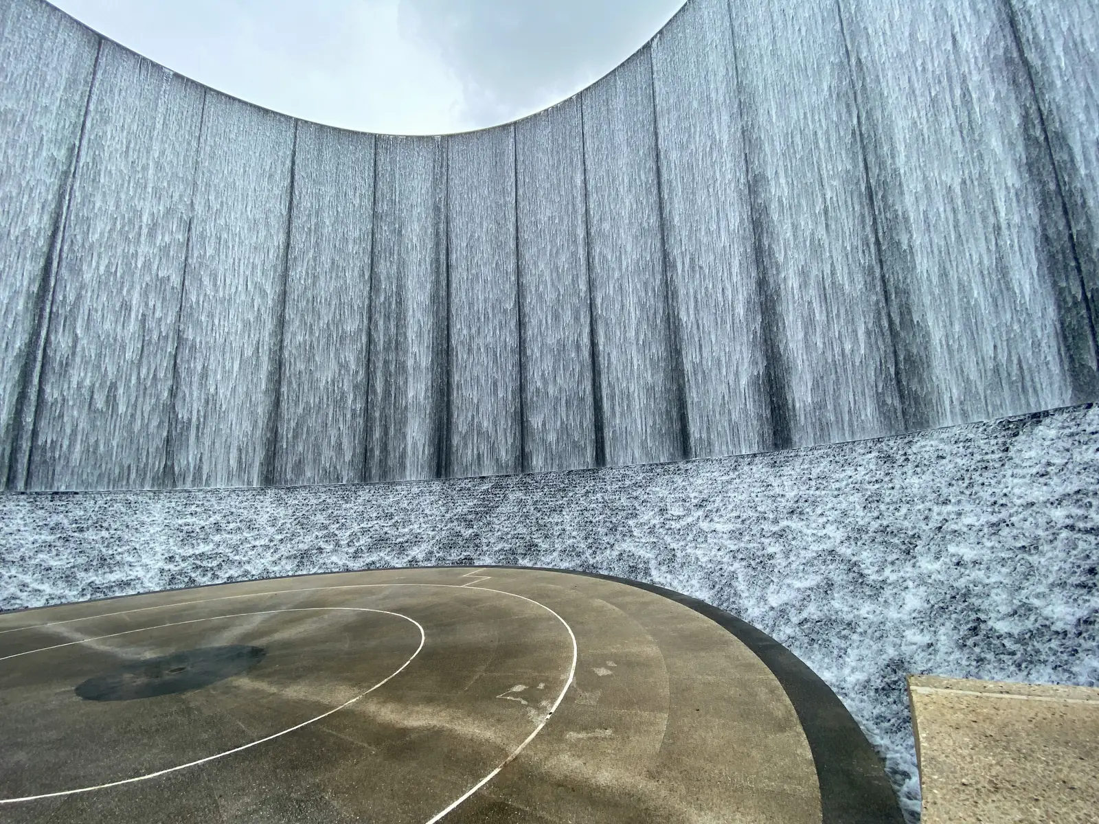 Water cascading down the curved Gerald D. Hines Waterwall in Houston