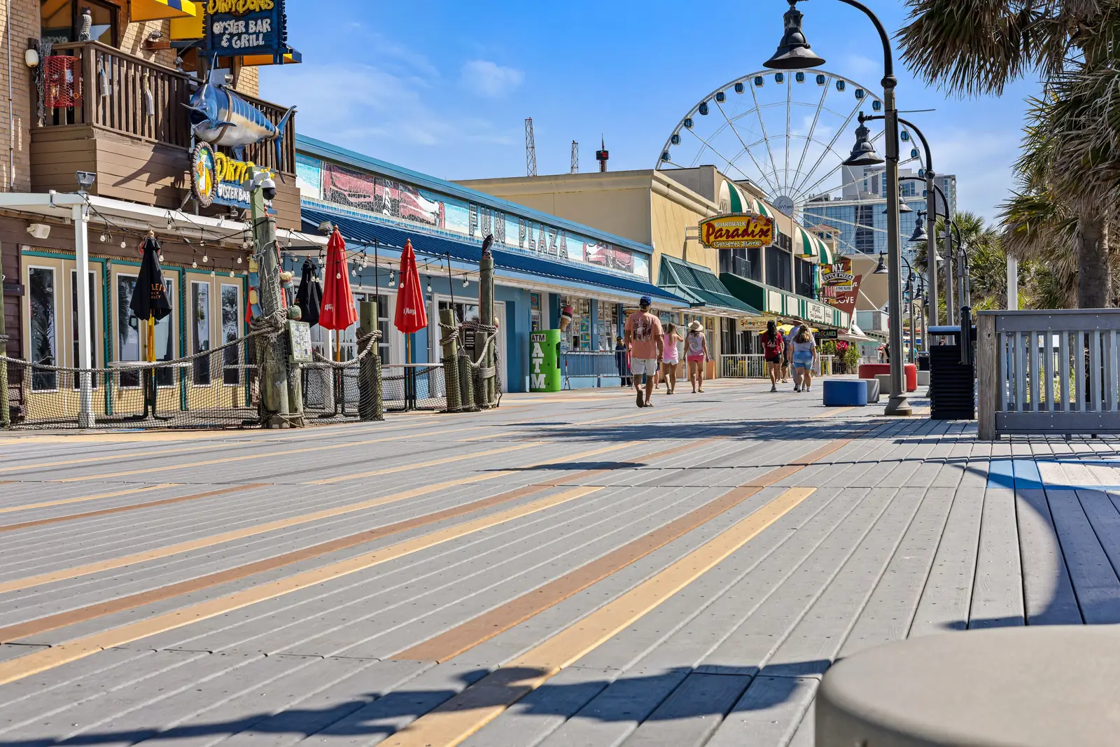 Shops and the SkyWheel along the Myrtle Beach Boardwalk on a sunny day