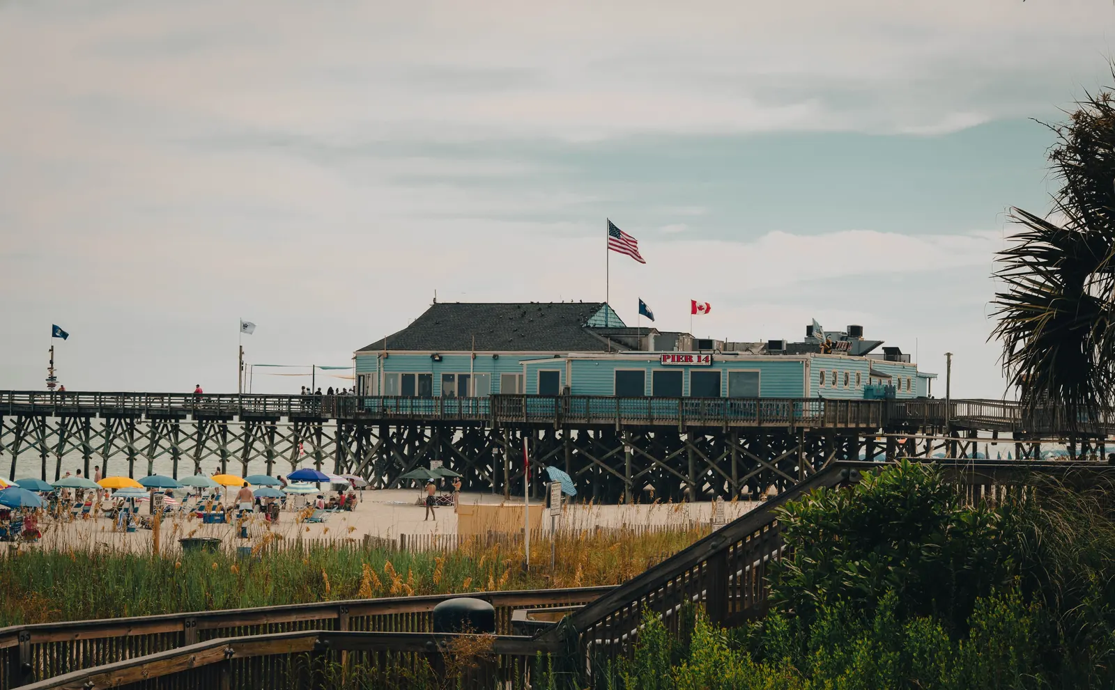 The wooden fishing pier and beach at Myrtle Beach, South Carolina