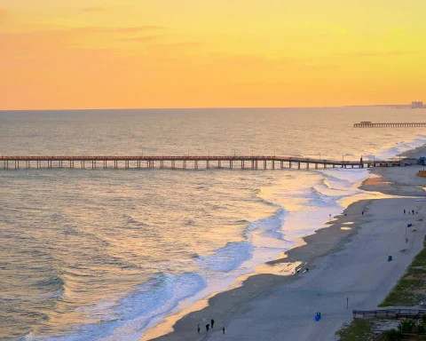 Aerial view of Myrtle Beach at sunset with the pier reaching into the ocean