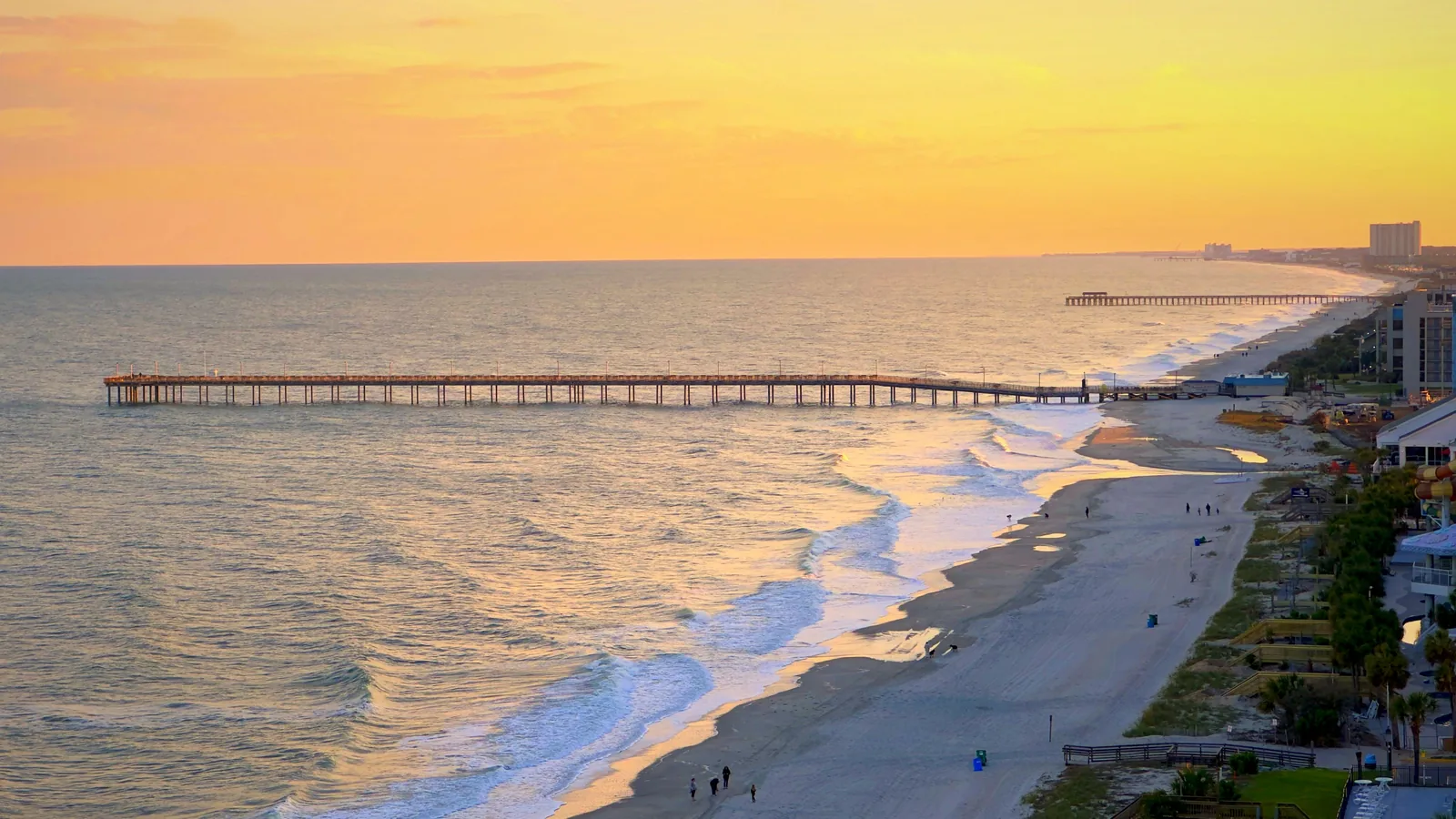 Aerial view of Myrtle Beach at sunset with the pier reaching into the ocean