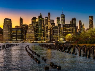 New York City skyline at sunset seen across the water from Brooklyn