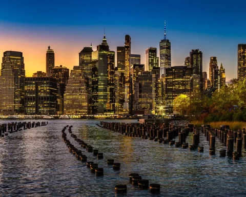 New York City skyline at sunset seen across the water from Brooklyn