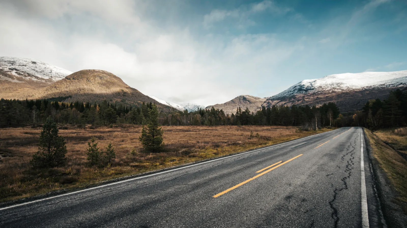 Empty highway winding through mountains on a scenic road trip