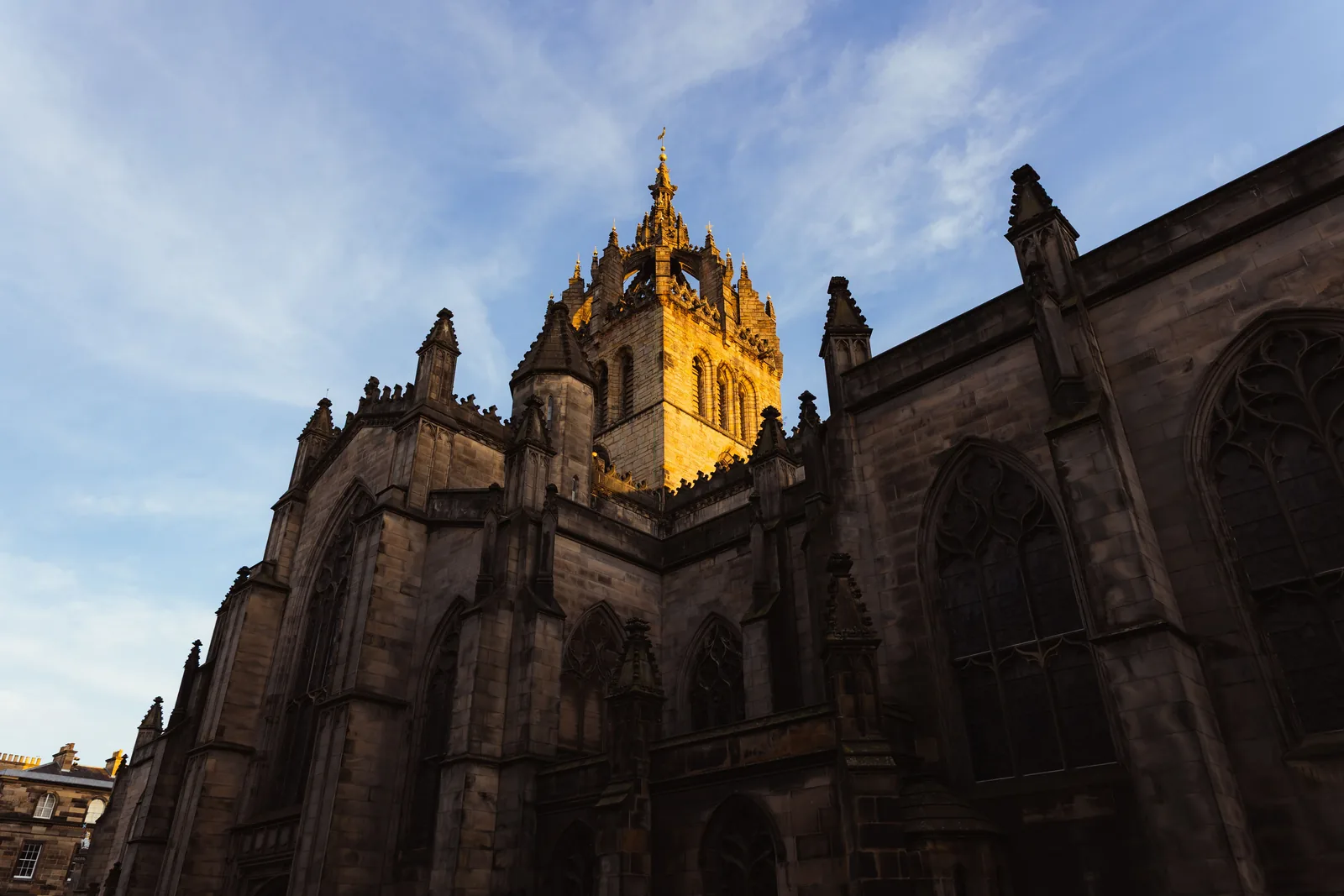 The crown-shaped spire of St Giles' Cathedral lit at sunset in Edinburgh
