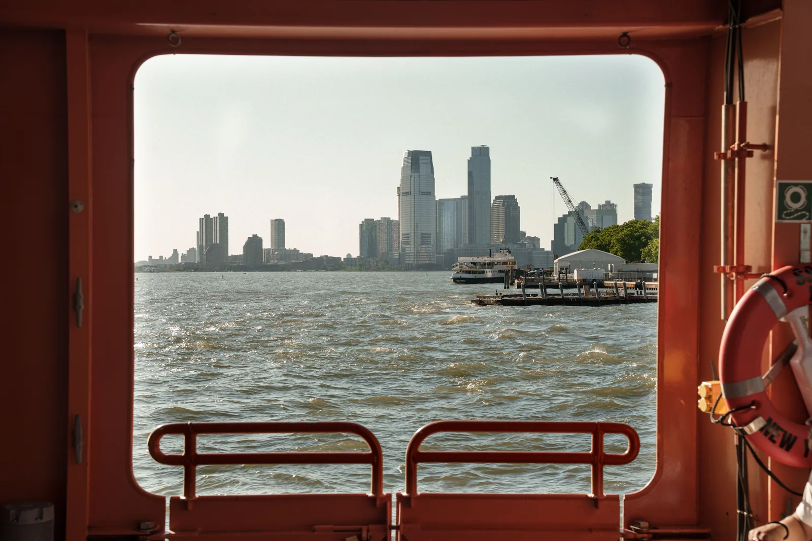 The Manhattan skyline seen through a window of the Staten Island Ferry