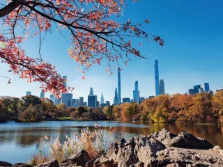 The Manhattan skyline seen across the Central Park lake in autumn