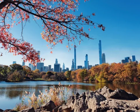 The Manhattan skyline seen across the Central Park lake in autumn