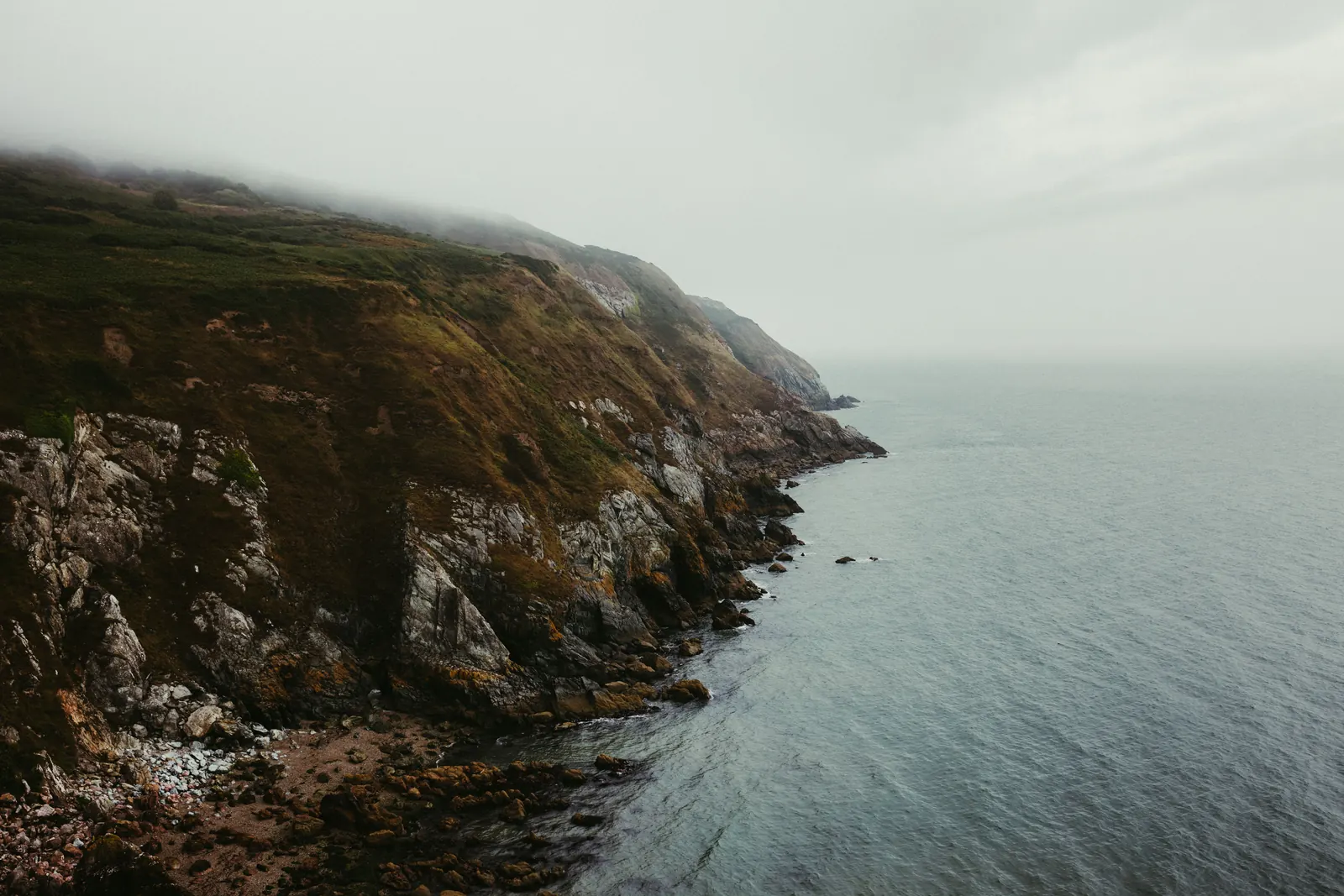 Mist rolling over the green cliffs at Howth on the Dublin coast