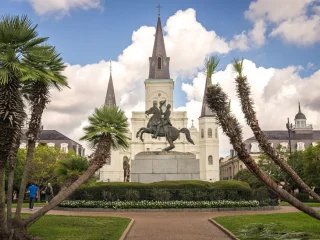 St. Louis Cathedral rising above Jackson Square behind palms in New Orleans