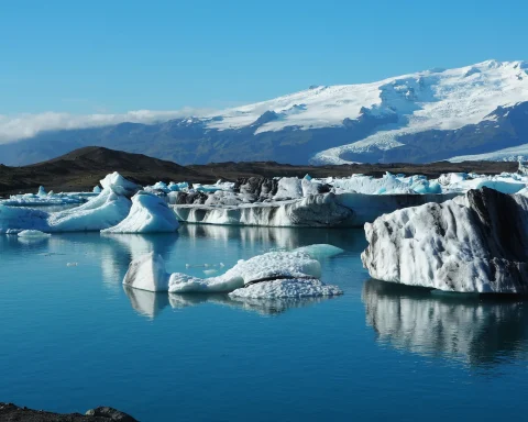 Icebergs floating on the still blue water of Jokulsarlon glacier lagoon in Iceland