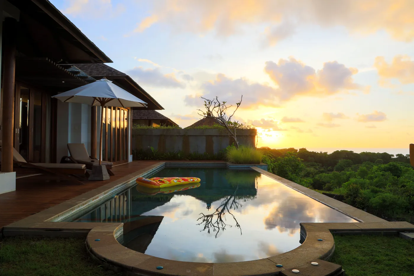 A villa infinity pool at sunset in Bali