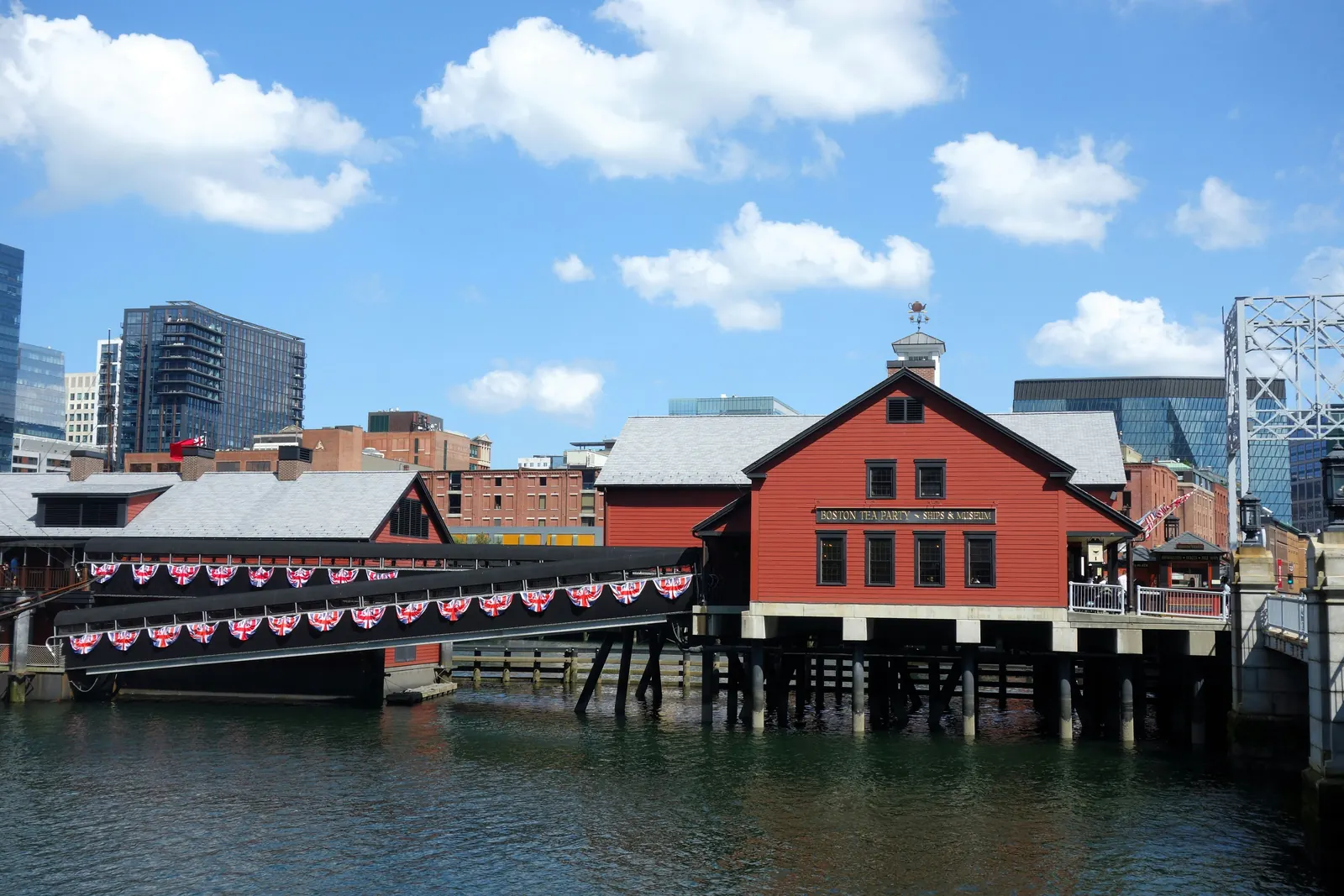 The red waterfront building of the Boston Tea Party Ships and Museum on the Fort Point Channel