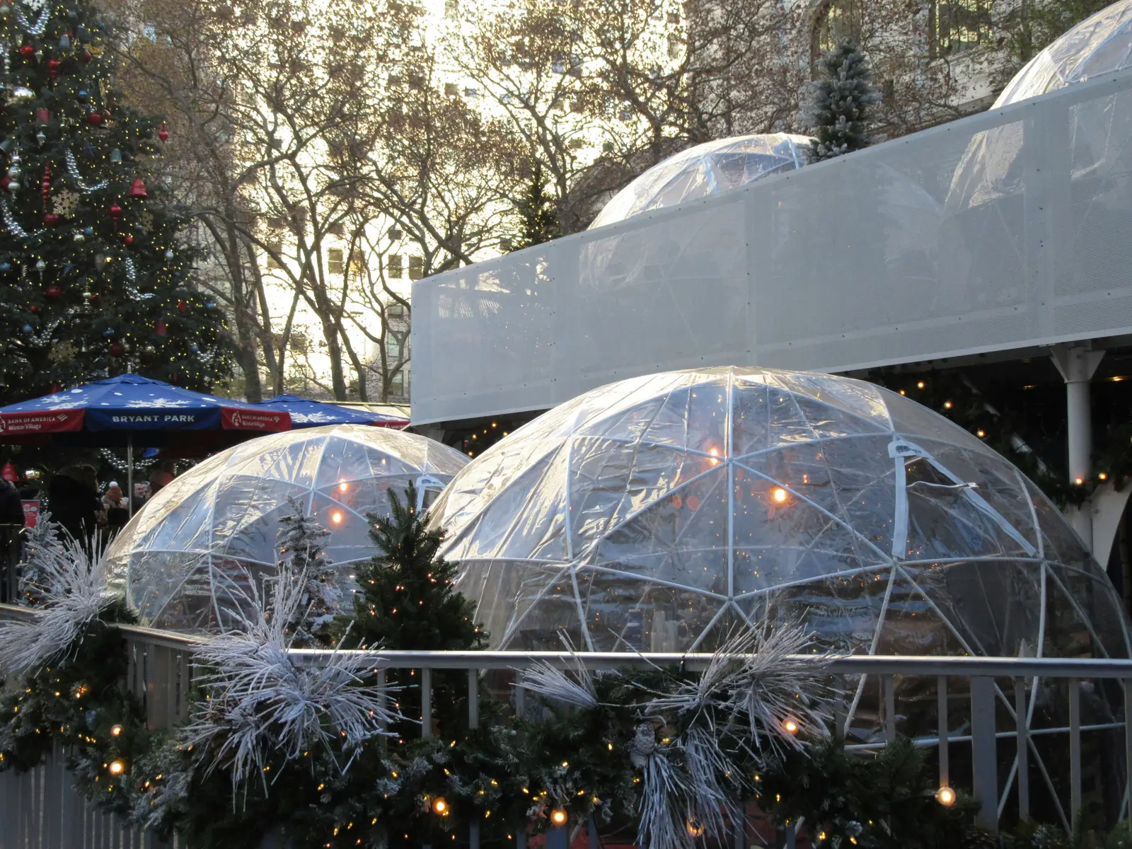 Clear igloo domes decorated for the holidays at the Bryant Park Winter Village