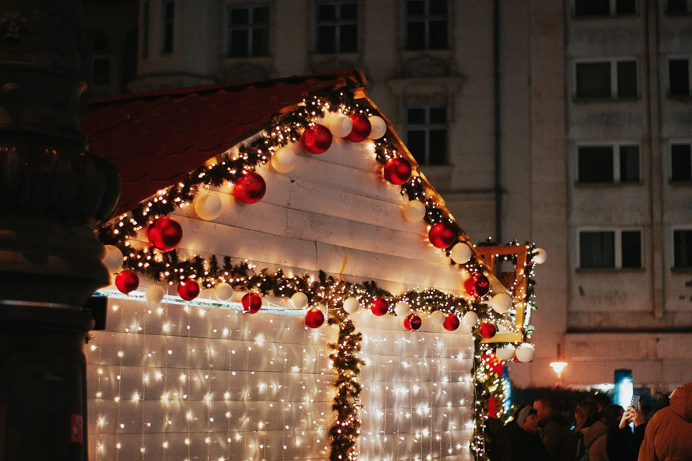A Christmas market stall in Budapest covered in fairy lights and red baubles