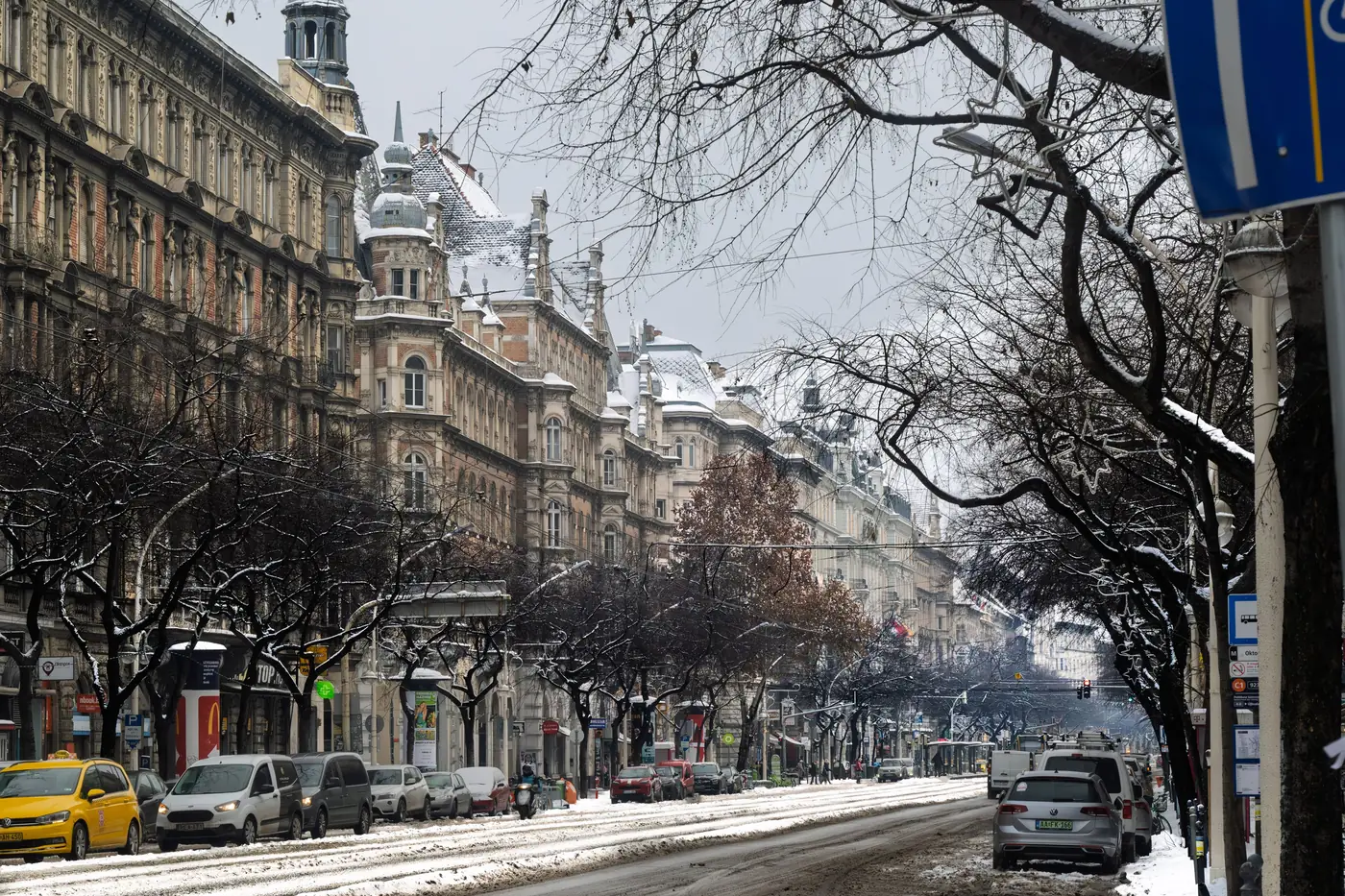 A snowy boulevard lined with historic buildings in Budapest