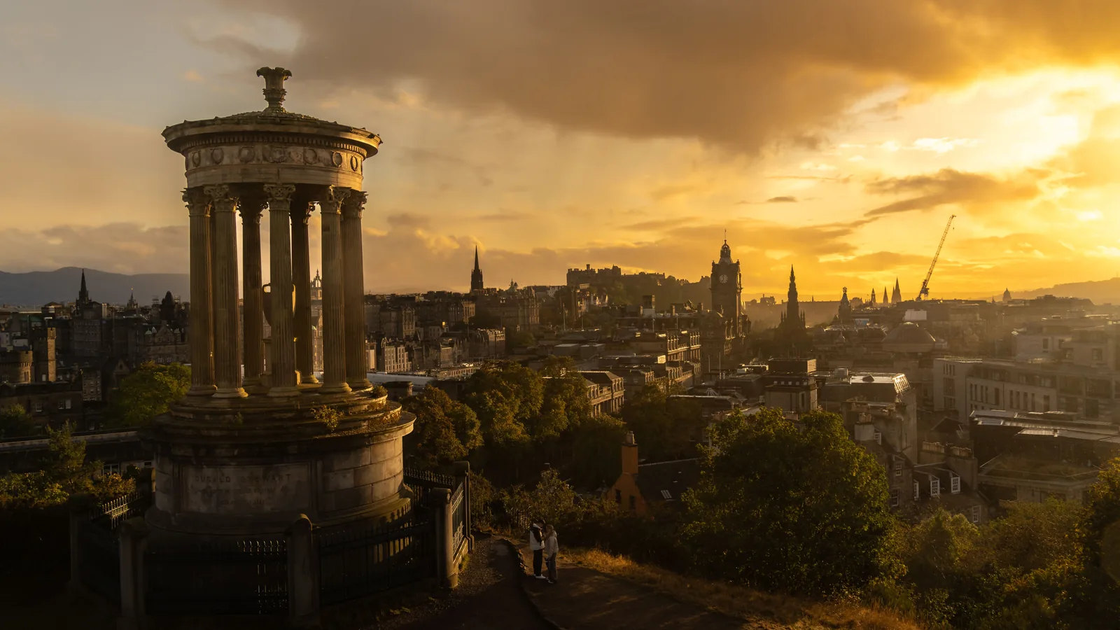 The Dugald Stewart Monument on Calton Hill at sunset over Edinburgh