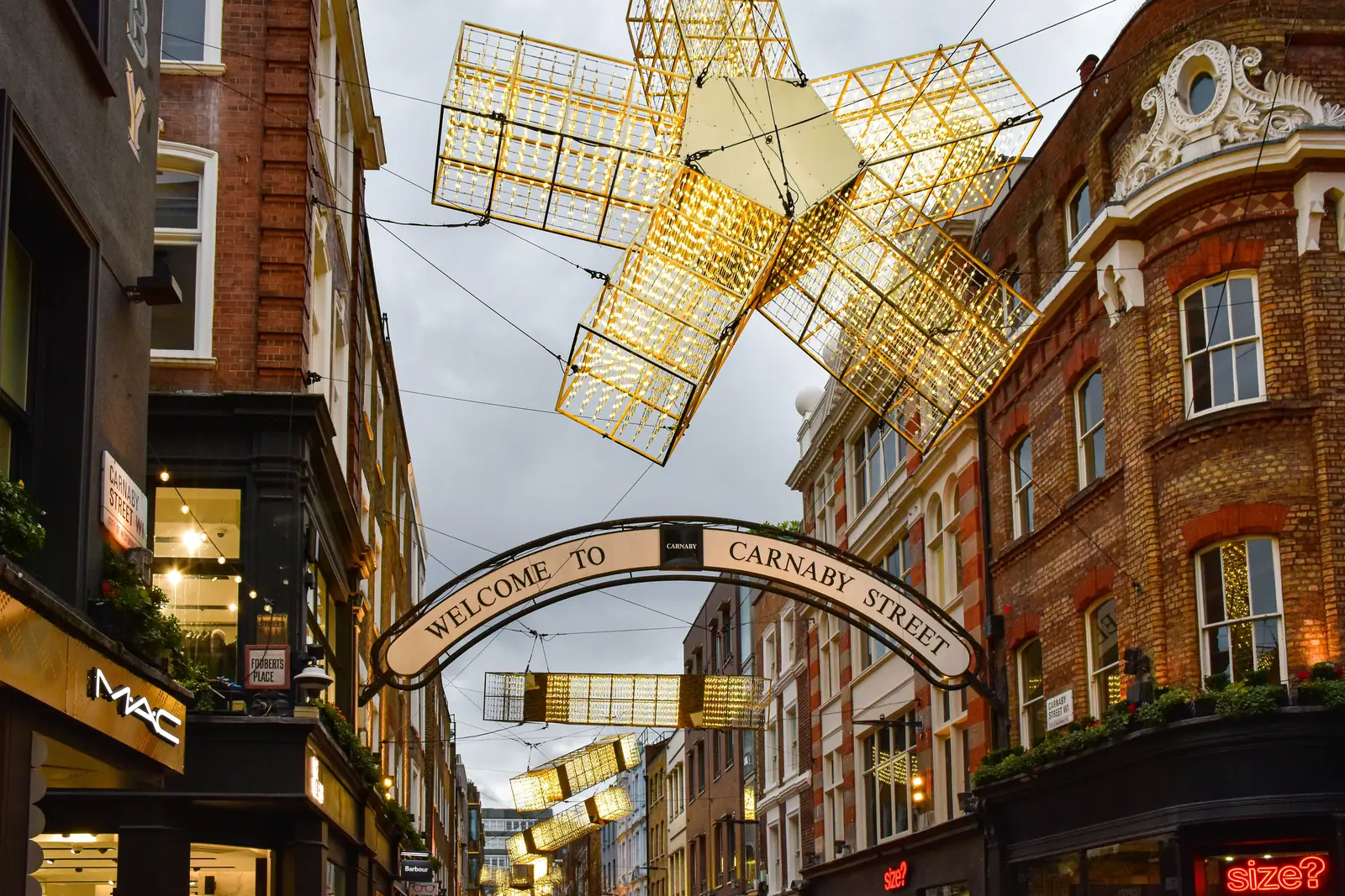 Festive light installations above the Welcome to Carnaby Street arch