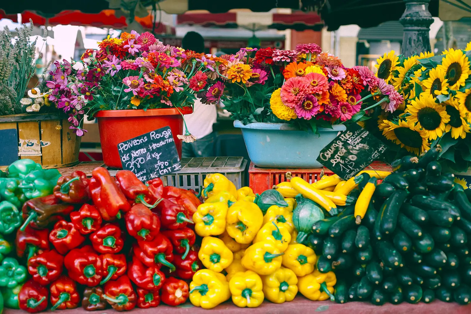 Vegetables and cut flowers on a stall at a farmers market