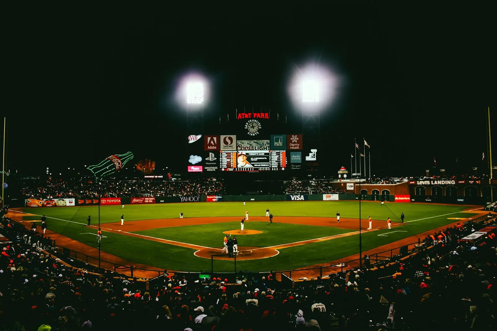 A batter at the plate during an evening baseball game