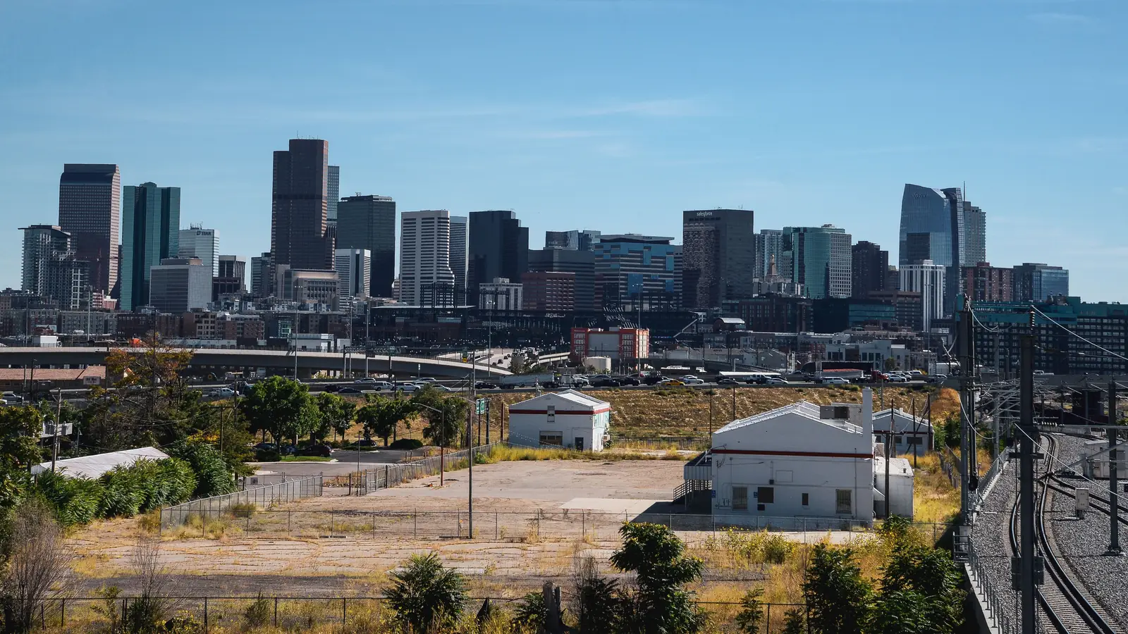 The downtown Denver skyline rising beyond the rail yards in Colorado
