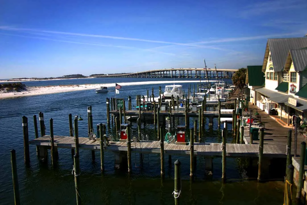 Charter fishing boats lined up along the docks at Destin Harbor