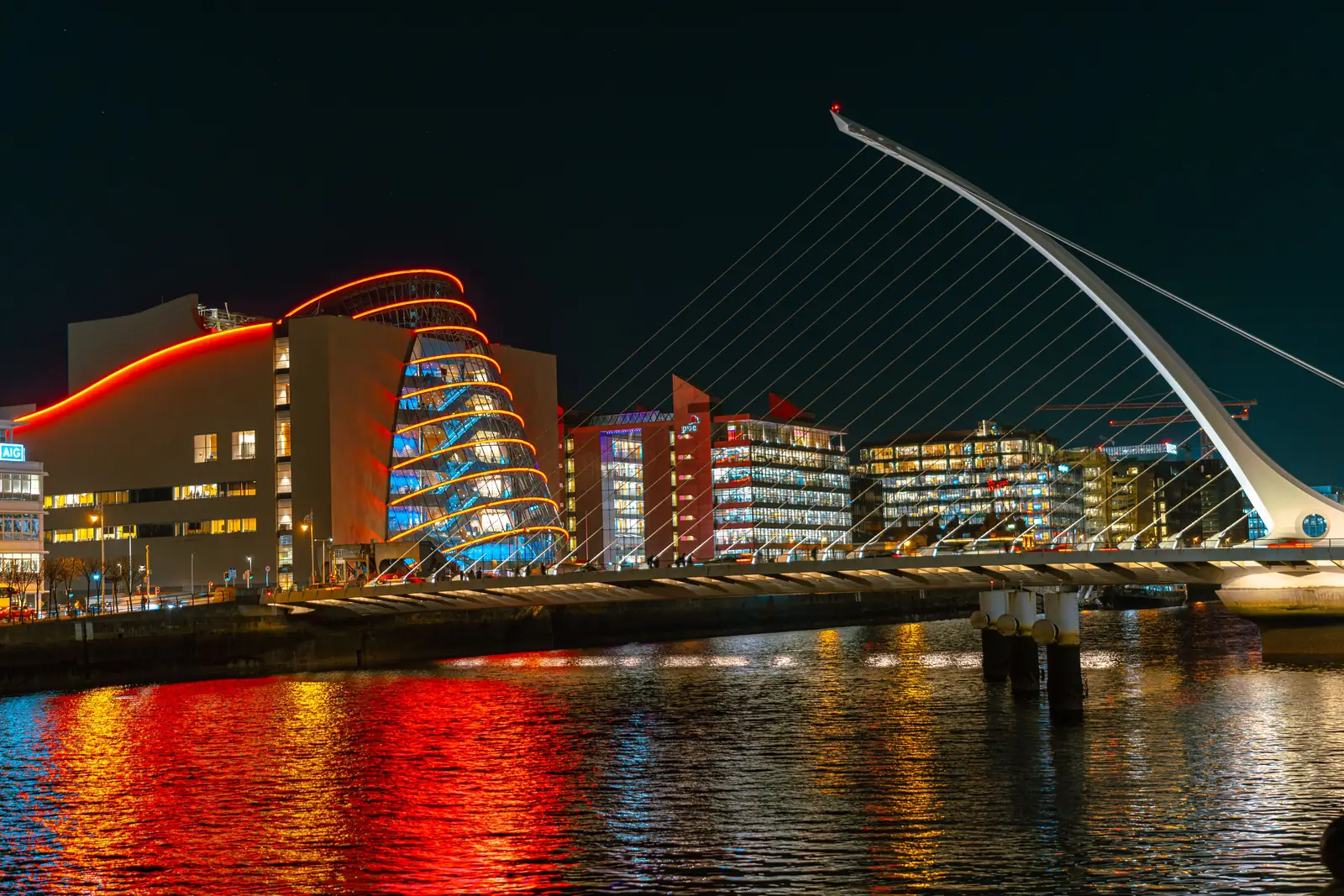 The Samuel Beckett Bridge lit up over the River Liffey at night