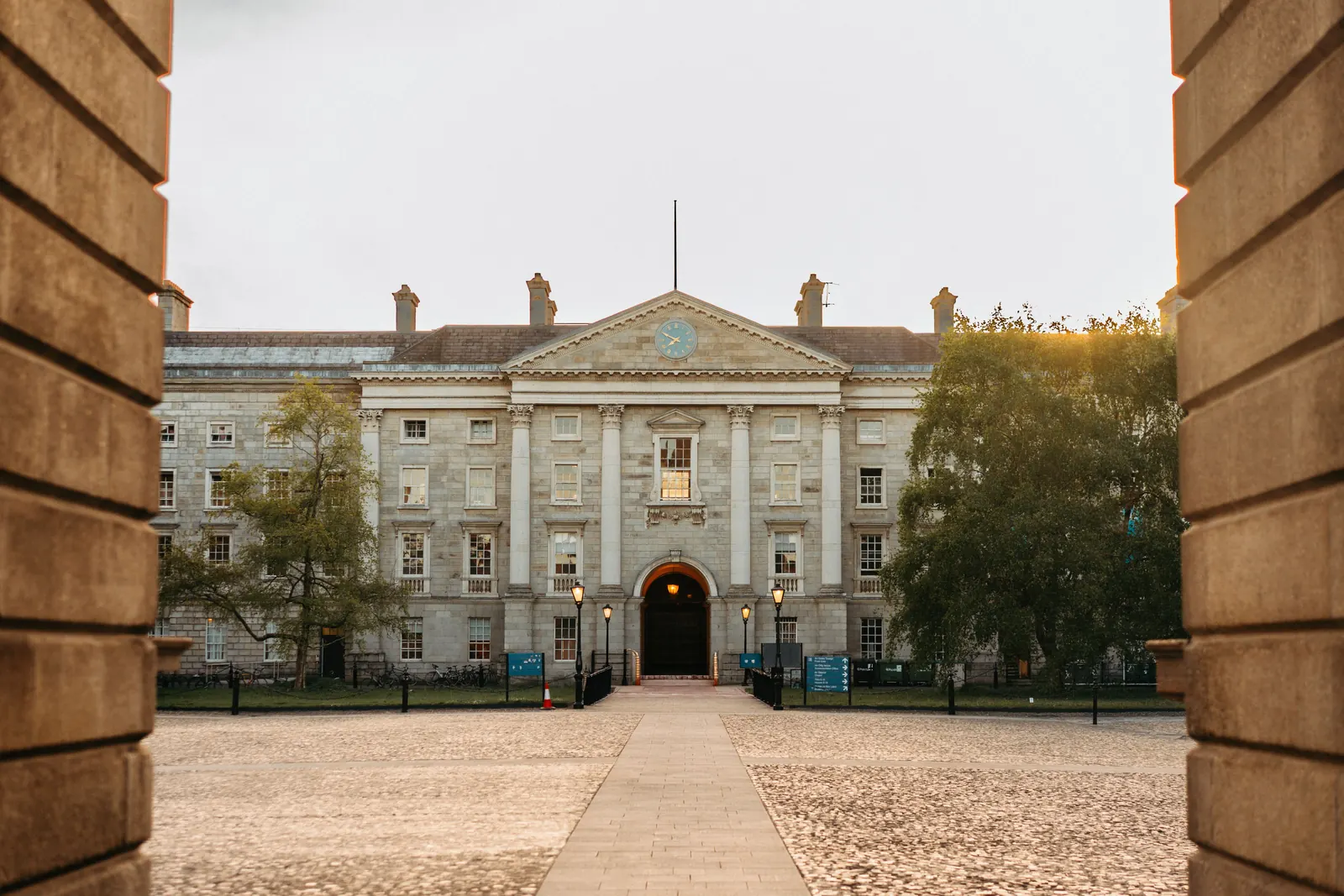 The front square of Trinity College Dublin seen through a stone arch