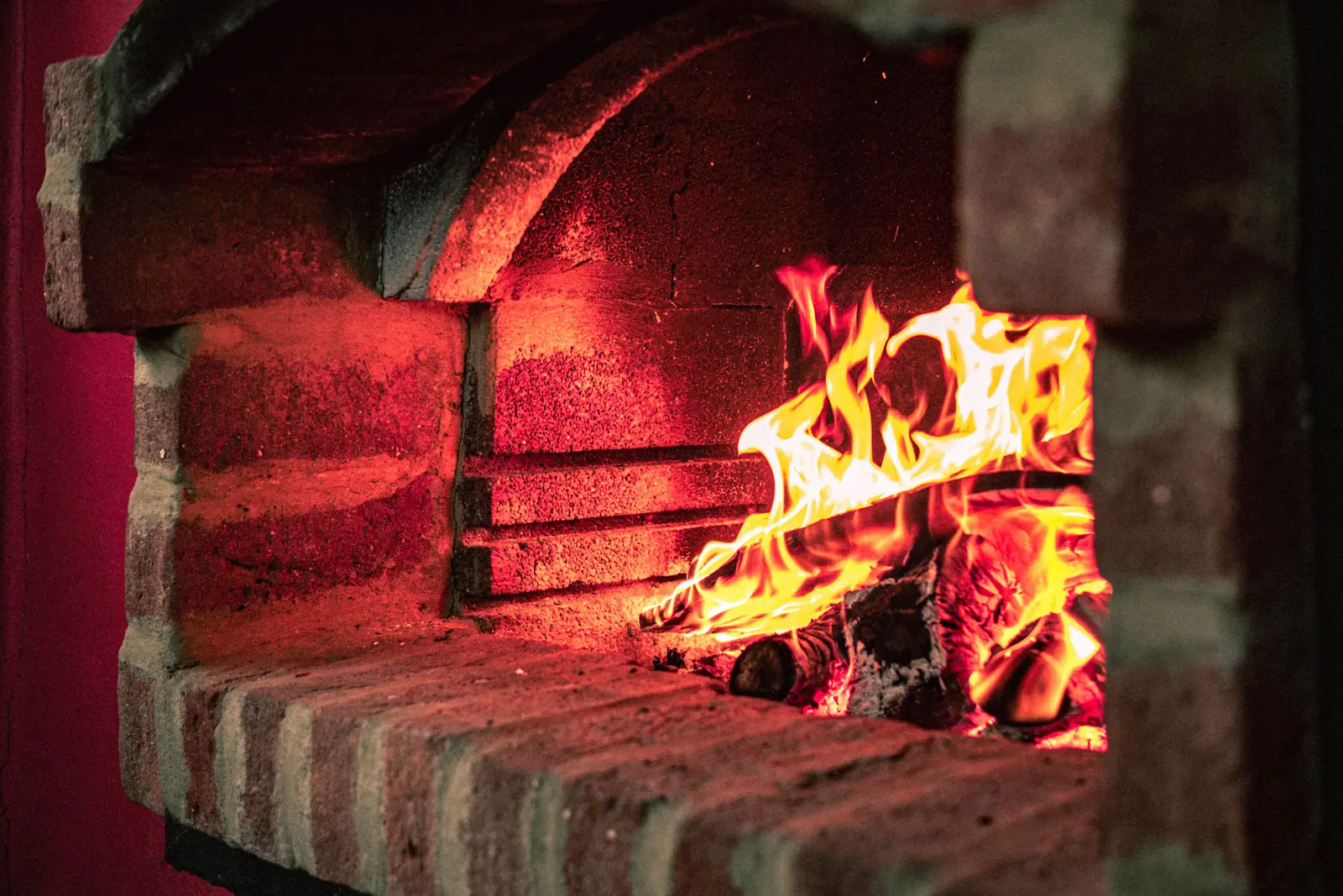 A fire burning in a brick fireplace