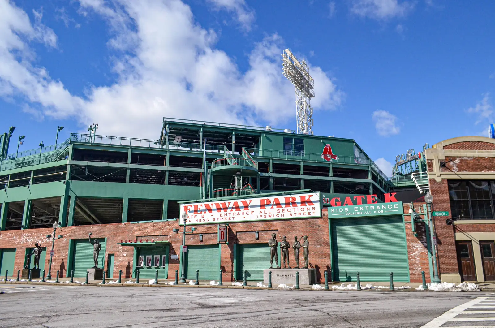 The green exterior wall and entrance gate at Fenway Park in Boston