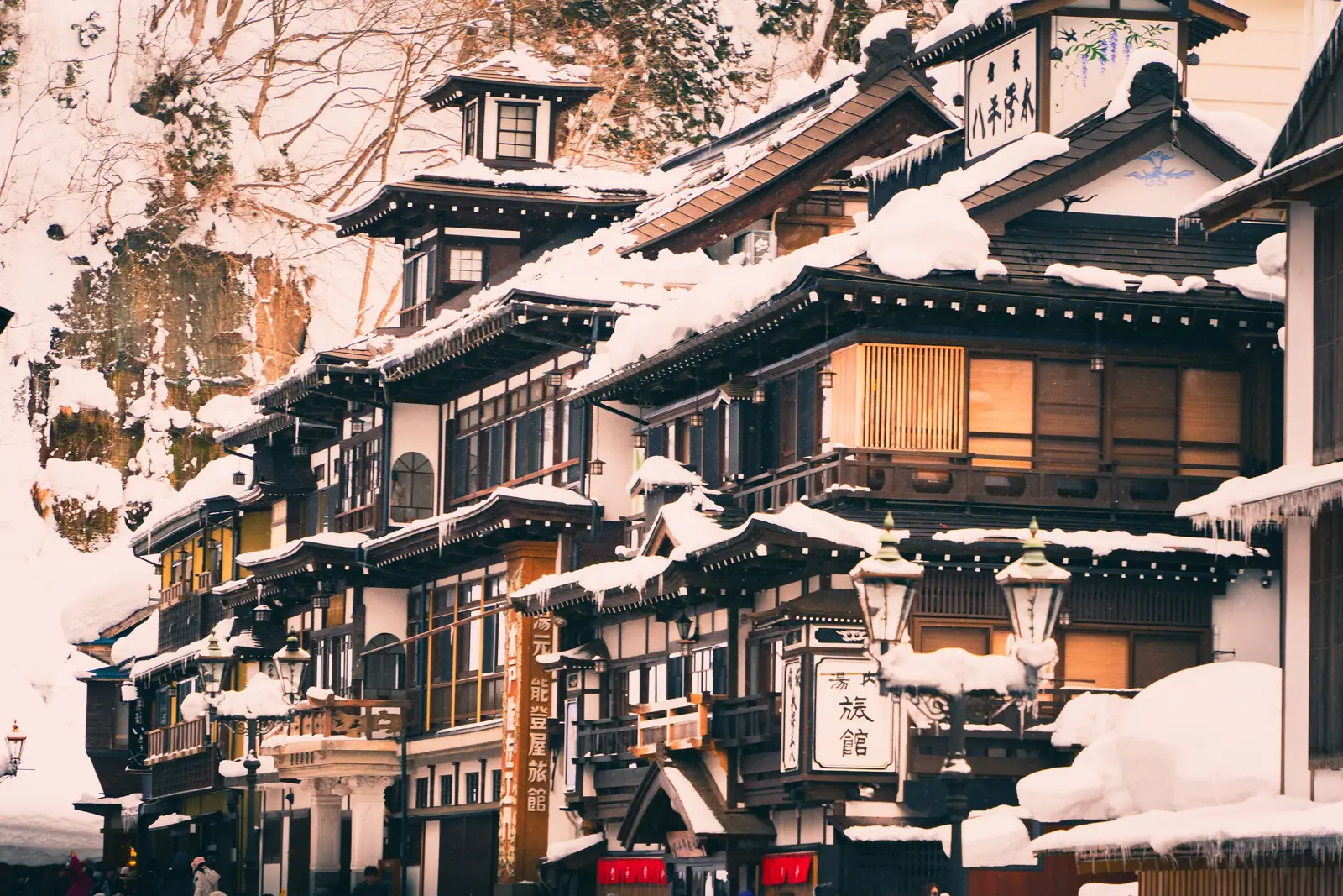 Wooden inns and gas lamps under deep snow at Ginzan Onsen