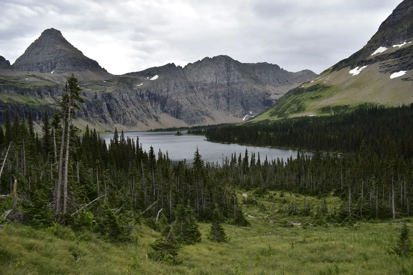 Grinnell Lake sitting in its basin below the peaks in Glacier National Park