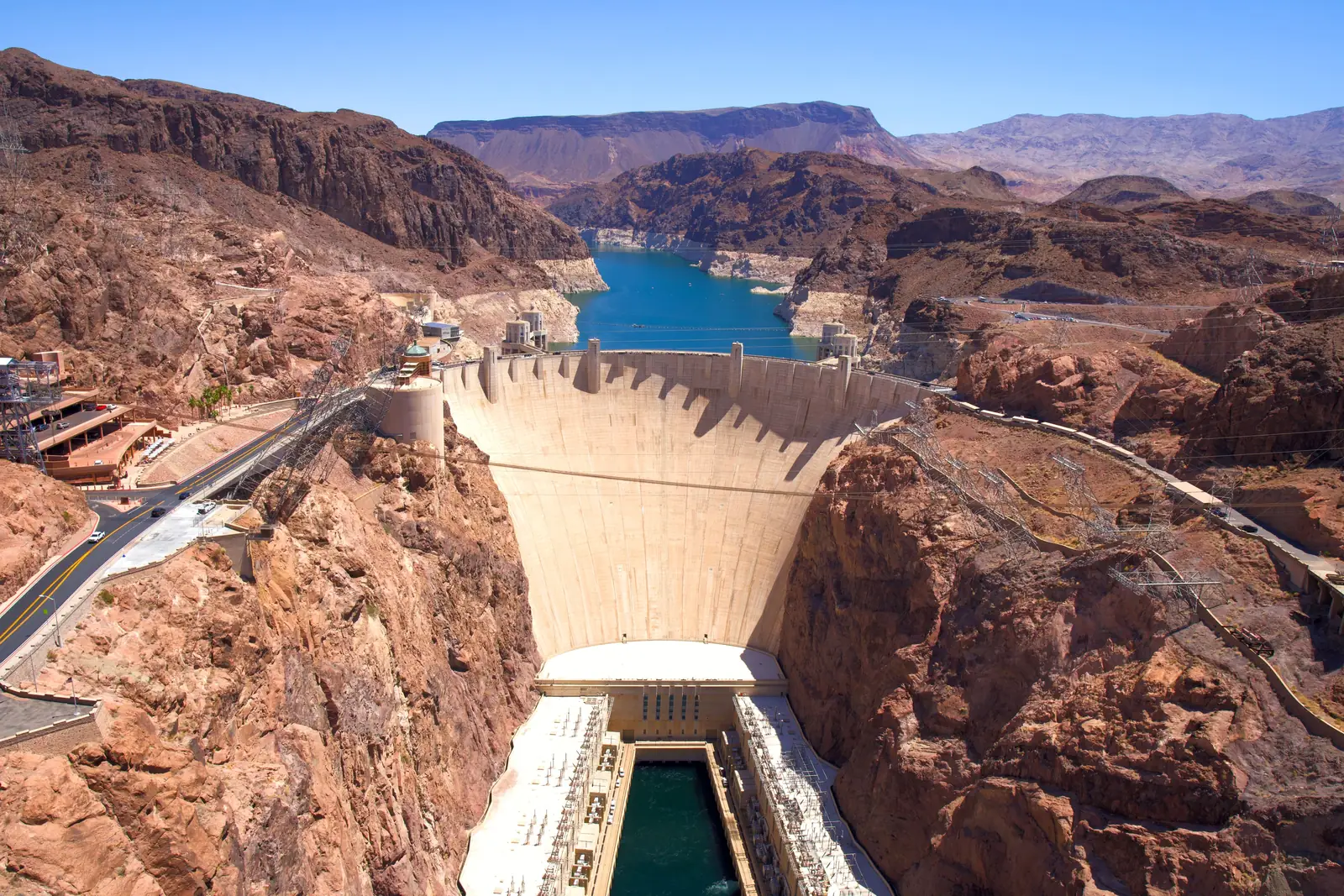 Hoover Dam curving between the canyon walls with Lake Mead behind it