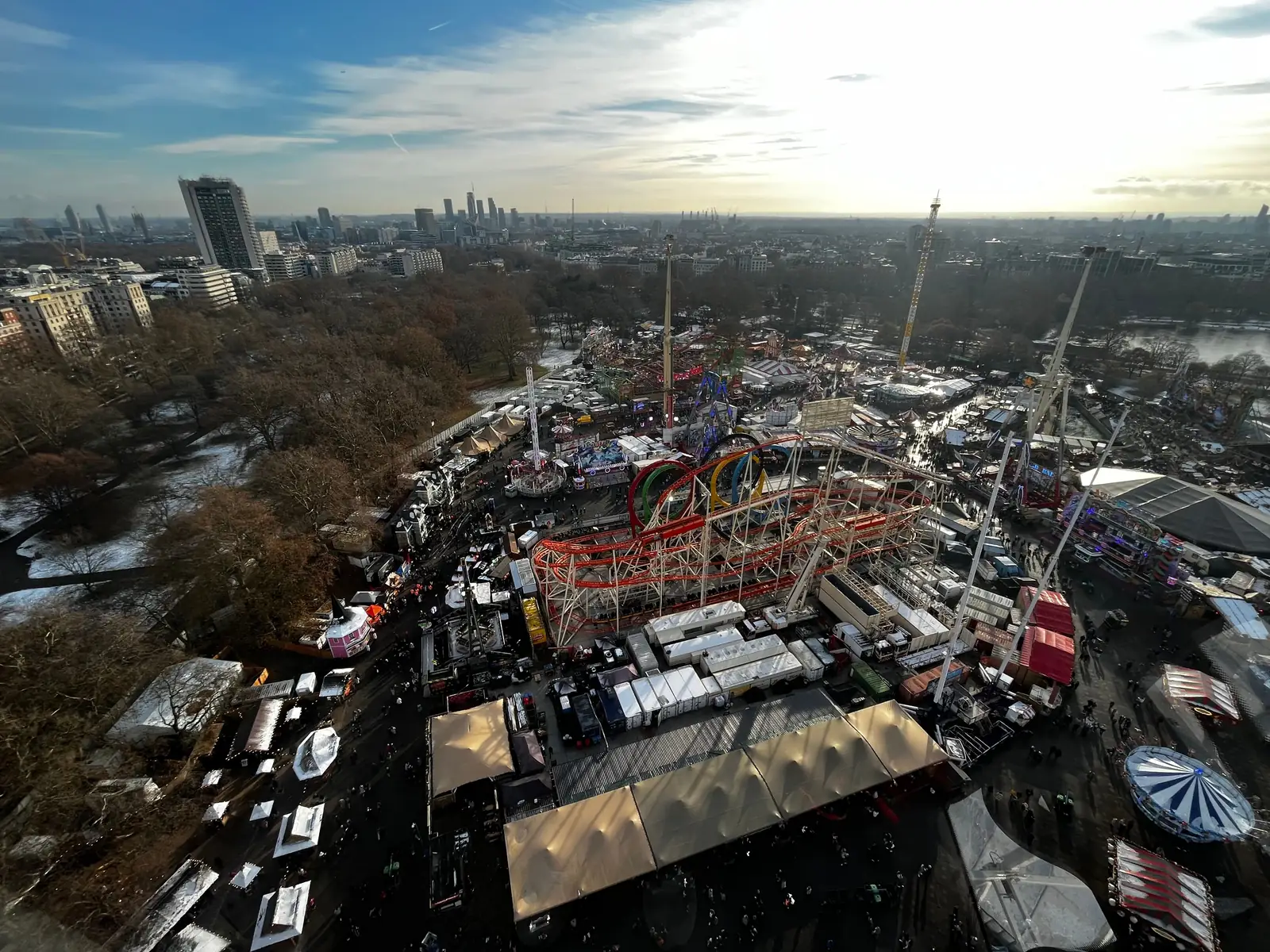Hyde Park Winter Wonderland lit up with the London skyline behind it