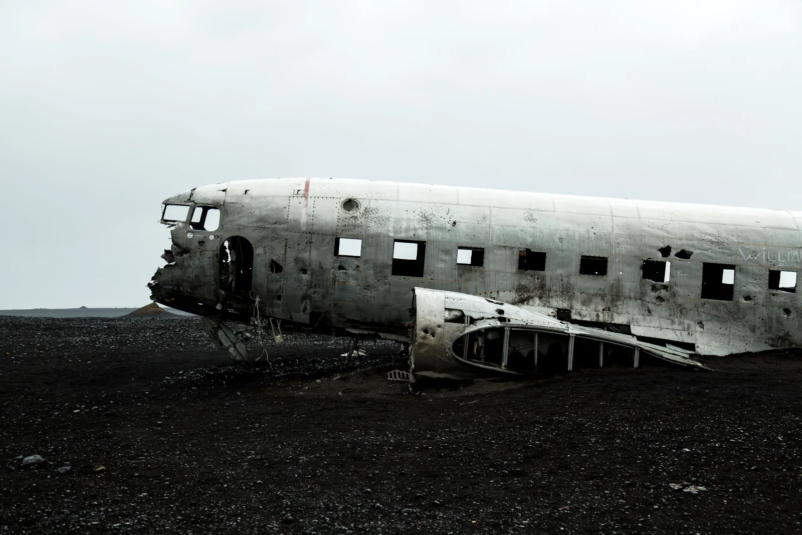 The stripped fuselage of the DC-3 plane wreck on the black sand at Solheimasandur