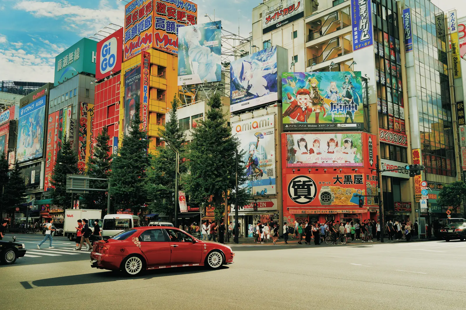 Tall signs and shopfronts along a street in Akihabara, Tokyo